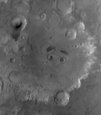 The "Eyes" and "Eyebrows" of Tikhonravov Crater (Original NASA/MGS/MSSS b/w Frame)
Caption NASA originale:"This red wide angle MGS-MOC image shows Tikhonravov Crater in Central Arabia Terra. The Crater is about 386 Km (approx. 240 miles) in diameter and presents two Unnamed Impact Craters at its center that have dark patches of Sand in them, giving the impression of pupils in two eyes. Each of these two Unnamed Craters lies a dark-toned patch of Surface Material, providing the impression of eyebrows. 
M. K. Tikhonravov was a leading Russian rocket engineer in the 20th Century. The crater named for him, despite its large size, is still partly buried, on its West Side, beneath the heavily Cratered Terrain of Arabia Terra. The center of Tikhonravov is near 13,5° North Lat. and 324,2° West Long. Sunlight illuminates the scene from the upper left".
Parole chiave: Mars from orbit - Craters - Tikhonravov Crater