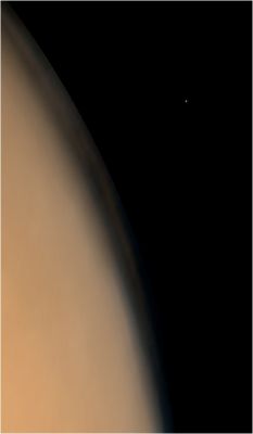 Martian Limb and Phobos (Natural Colors; credits: NASA/MGS/MSSS)
Una spettacolare veduta del bordo ("limb") di Marte e della sua luna "misteriosa", Phobos, la quale costituisce anche uno degli oggetti più "bui" dell'intero Sistema Solare. Ecco il commento originale a questa immagine:
"Phobos is one of the darkest objects in the Solar System. Thus, 4 wide angle images were obtained to make the picture of Phobos over the martian limb: a pair of red and blue wide angle images was acquired for the limb and a pair of separate images were required to see Phobos. The wide angle images illustrate the fact that Phobos is mostly colorless (dark gray); the faint orange/red hue in the wide angle picture is a combination of slight differences in the focal lengths of the blue and red cameras and the orange/red illumination provided by reflection of sunlight off Mars. To a person standing on Phobos, the Red Planet would fill most of the sky". 
Parole chiave: Mars' Moons - Phobos