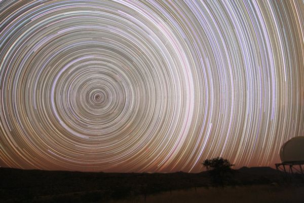 Inside the Vortex...
Fix your camera to a tripod, lock the shutter open, and you can make an image of star trails - graceful concentric arcs traced by the stars as planet Earth rotates on its axis. Of course, the length of the star trails will depend on the exposure time. While exposures lasting just five minutes produce a significant arc, in about 12 hours a given star would trace out half a circle. But in any long exposure, the background glow from light-polluted skies can build up to wash out the trails. Still, astronomer Josch Hambsch produced this stunning composite of star trails around the South Celestial Pole with an effective "all night" exposure time of almost 11 hours. To do it, he combined 128 consecutive five minute long digital exposures recorded in very dark night skies above Namibia. In his final image, the background glow on the right is due in part to the faint, arcing Milky Way.
Parole chiave: The Universe Inside