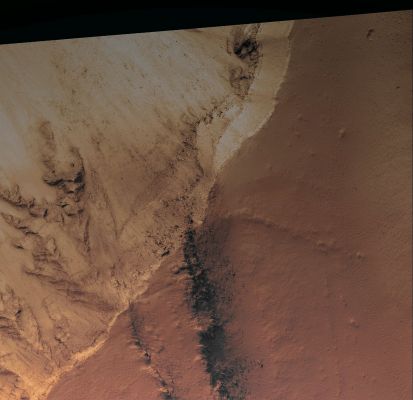 Intersection between Hyblaeus and Elysium Chasmata (EDM n.1 - Saturated Natural Colors; credits for the additional process. and color.: Dr Paolo C. Fienga - Lunexit Team)
A cross-section of Hyblaeus Chasma is visible in this first extra-detail mgnf). 
The chasm seems to be filled with a resistant light-toned layer, about 200 mt thick (likely consisting of cemented windblown sand and dust) forming a mantling unit and overlying more resistant boulder-rich layers. The sand and dust was likely blown into Hyblaeus Chasma after it was formed by tectonic processes, possibly in combination with fluvial processes. 
The chasmata were subsequently broadened by hillslope erosion: boulders are strewn along the top of this dusty mantling unit. Slumping, possibly caused by faulting, along the Southern Wall of Hyblaeus is visible at the intersection with Elysium Chasma.

This image also shows a number of dark streaks along the walls of Elysium Chasma, further to the south.
Parole chiave: Mars from orbit - The Wall of Hyblaeus Chasma