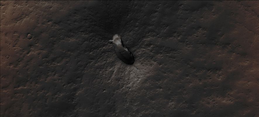 The "Footprint" Volcano (Absolute Natural Colors; credits for the additional process. and color.: Drr Don P. Mitchell and Paolo C. Fienga - Lunexit Team)
This NASA - Mars Global Surveyor (MGS) - Mars Orbiter Camera (MOC) High Resolution image, acquired on the date of July, 13, 2003, shows a small, Dust-covered and so far - officially - Unnamed Volcano (note: the nickname "Footprint" has been given to this Surface Feature by the Researchers of the Italian Planetary Foundation) that is located on the Volcanic Plains to the East of the Giant Martian Volcano, Pavonis Mons. 
It is interesting to notice that the Floor of the Caldera - such as the elliptical depression visible at the Summit of the Volcano - has a few windblown Ripples on it. The Ripples and the extremely thick Dust Mantle, together with a number of small Impact Craters located on its Surface, are signs which indicate that the "Footprint" Volcano erupted a VERY long time ago, and that there has been no more activity in (geologically speaking) recent times. In addition to the above, we also wish to underline that, while the Surface surrounding the Footprint Volcano has kept, despite the eons of volcanic idleness, a dark gray color (such as the typical colors of Lava, once is cooled off, and Volcanic Ashes), the Land that is farther away from the Volcano has maintained (or maybe re-gained?) the typical brown-orange color which characterizes most of the Equatorial and Peri-Equatorial Surface of Mars. This image covers an area approx. 3 by 6,8 Km wide (such as approx. 1,9 by 4,2 miles). The Footprint Volcano is located near 1,6° South Lat. and 105,7° West Long.; the Sunlight illuminates the scene from the South.
The frame has been colorized in Absolute Natural Colors (such as the colors that a human eye would actually perceive if someone were onboard the NASA - Mars Global Surveyor Orbiter and then looked down, towards the Surface of Mars), by using an original technique created - and, in time, dramatically improved - by the Lunar Explorer Italia Team.
Parole chiave: Mars from orbit - Volcanoes - Footprint